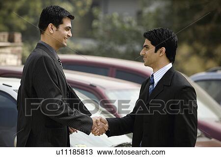Stock Image - Executives sealing the deal . Fotosearch