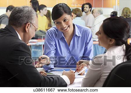 Executives talking business in a restaurant View Large Photo Image Stock Photo - Executives talking business in a restaurant . Fotosearch