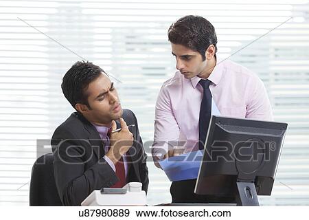Stock Photo - Executives talking over new business project . Fotosearch