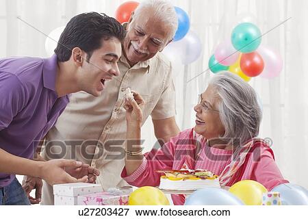 Family celebrating birthday View Large Photo Image Stock Photo - Family celebrating birthday. Fotosearch