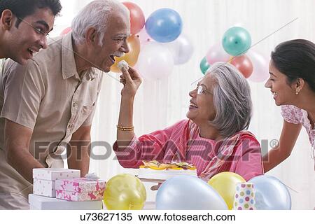 Family celebrating birthday View Large Photo Image Stock Photography - Family celebrating birthday. Fotosearch