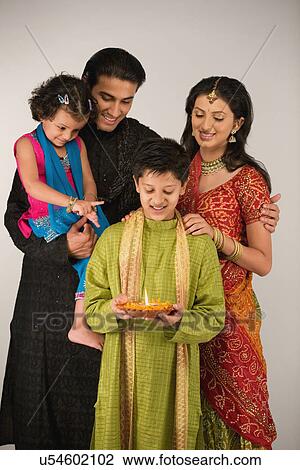 Family celebrating diwali View Large Photo Image Stock Image - Family celebrating diwali . Fotosearch