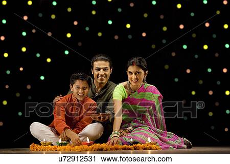 Family celebrating diwali View Large Photo Image Stock Image - Family celebrating diwali . Fotosearch