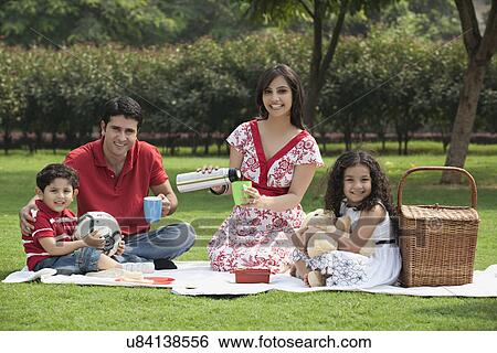 Stock Photograph - Family enjoying at a picnic . Fotosearch