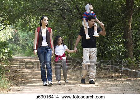 Family going for a walk in a park View Large Photo Image Picture - Family going for a walk in a park . Fotosearch