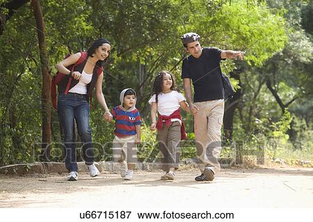 Family going for a walk in a park View Large Photo Image Stock Photo - Family going for a walk in a park . Fotosearch