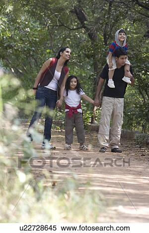 Family going for a walk in a park View Large Photo Image Stock Photography - Family going for a walk in a park . Fotosearch