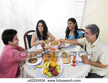 Family having breakfast View Large Photo Image Picture - Family having breakfast . Fotosearch