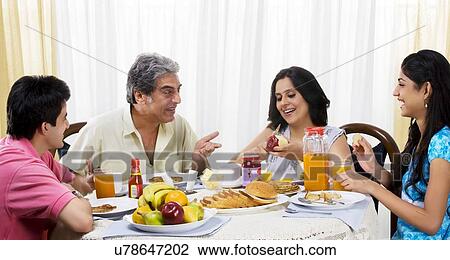 Stock Image - Family having breakfast . Fotosearch