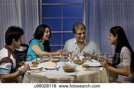 Family having dinner View Large Photo Image Stock Photo - Family having dinner . Fotosearch