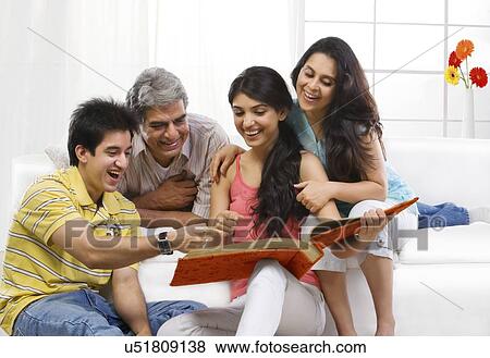 Family looking at the family album View Large Photo Image Stock Photo - Family looking at the family album . Fotosearch