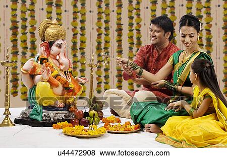 Stock Photo - Family performing a pooja . Fotosearch