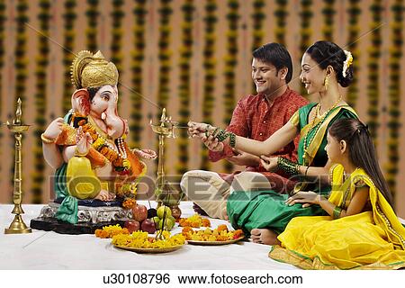 Family performing a pooja View Large Photo Image Stock Photograph - Family performing a pooja . Fotosearch
