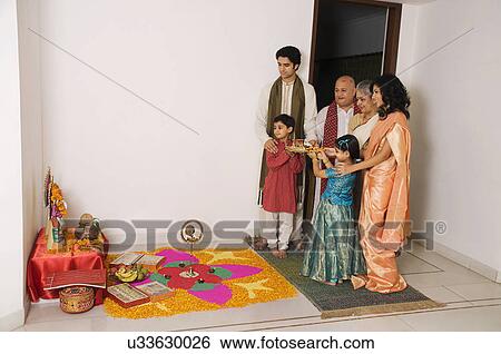 Family performing a pooja View Large Photo Image Stock Photograph - Family performing a pooja . Fotosearch
