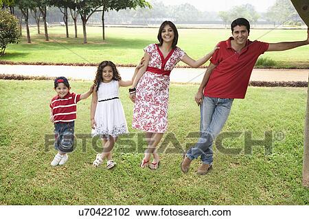 Stock Image - Family posing in a park . Fotosearch