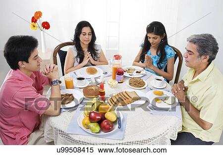 Family praying before having breakfast View Large Photo Image Stock Photography - Family praying before having breakfast . Fotosearch