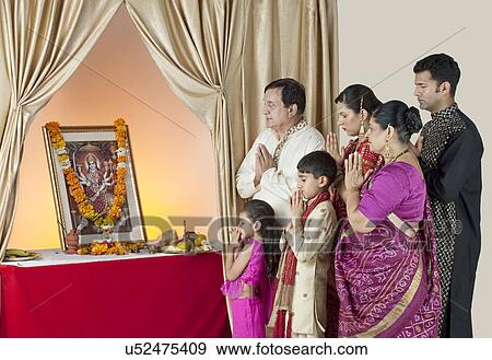 Stock Photo - Family praying . Fotosearch