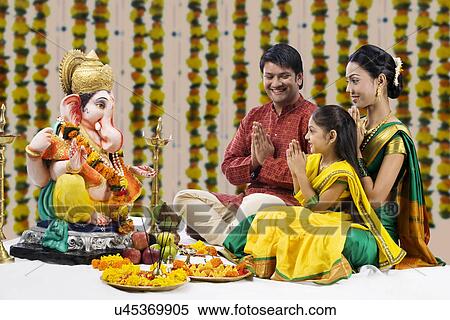 Stock Photography - Family praying . Fotosearch