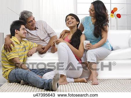 Stock Image - Family sitting together in the living room . Fotosearch