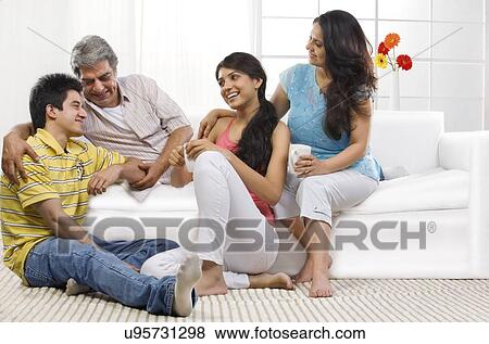 Family sitting together in the living room View Large Photo Image Stock Photo - Family sitting together in the living room . Fotosearch
