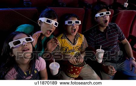 Family watching a movie with 3D glasses View Large Photo Image Stock Photo - Family watching a movie with 3D glasses . Fotosearch