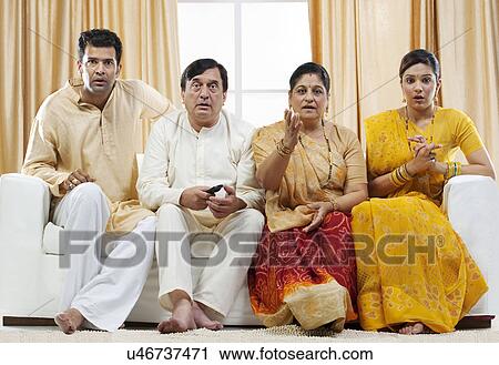Stock Image - Family watching television . Fotosearch
