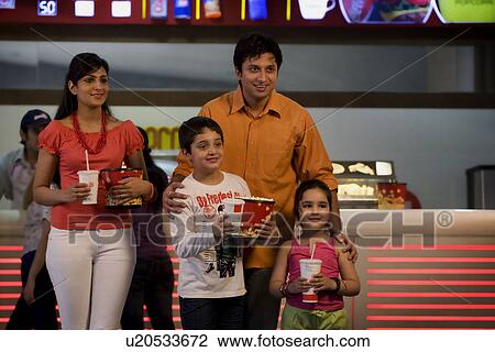 Stock Image - Family with cola and popcorn . Fotosearch