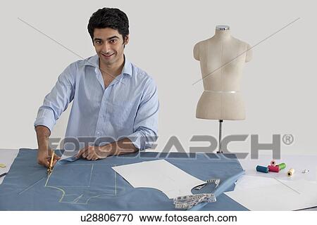 Fashion designer working in fashion studio View Large Photo Image Stock Image - Fashion designer working in fashion studio . Fotosearch