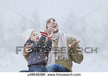 Father and son enjoying winter View Large Photo Image Stock Photograph - Father and son enjoying winter . Fotosearch