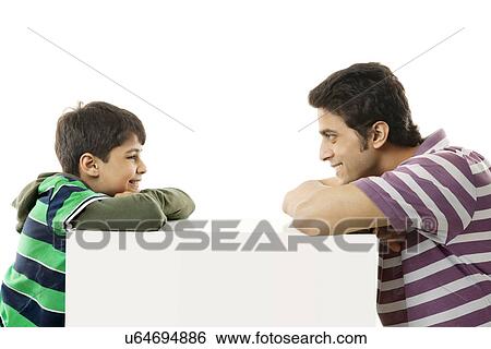 Father and son looking at each other View Large Photo Image Stock Photograph - Father and son looking at each other . Fotosearch