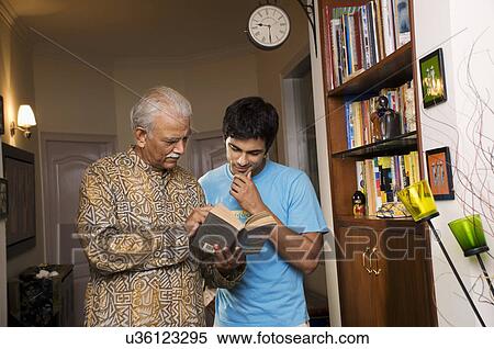 Father and son reading a book View Large Photo Image Stock Photography - Father and son reading a book . Fotosearch