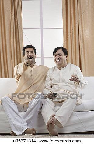 Father and son watching television View Large Photo Image Picture - Father and son watching television . Fotosearch
