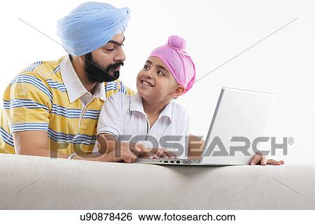 Father and son with a laptop View Large Photo Image Stock Photograph - Father and son with a laptop . Fotosearch