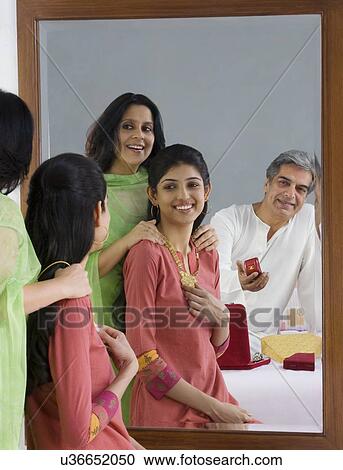 Stock Image - Father giving a ring to his daughter . Fotosearch
