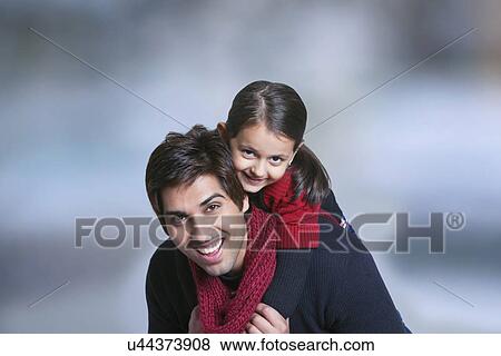 Father giving girl piggy back ride outdoors View Large Photo Image Stock Photo - Father giving girl piggy back ride outdoors . Fotosearch