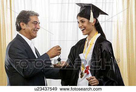 Stock Photo - Father giving his daughter his car keys . Fotosearch