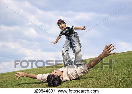 Stock Photo - Father playing with his son . Fotosearch