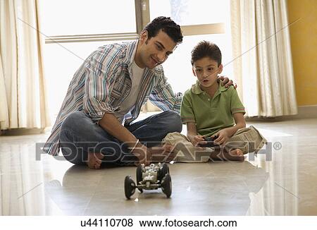 Stock Photo - Father playing with his son . Fotosearch
