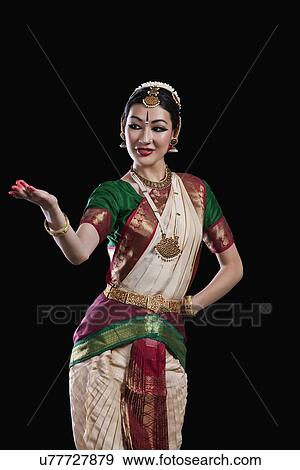 Female Bharat Natyam dancer performing over black background View Large Photo Image Stock Photo - Female Bharat Natyam dancer performing over black background. Fotosearch