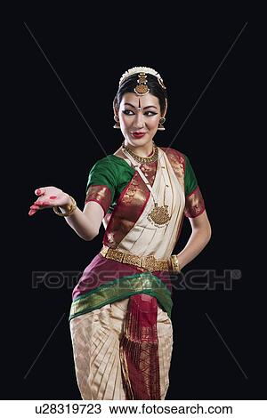 Stock Image - Female Bharata Natyam performer over black background. Fotosearch