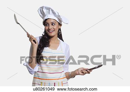 Stock Photo - Female chef with cooking utensils. Fotosearch