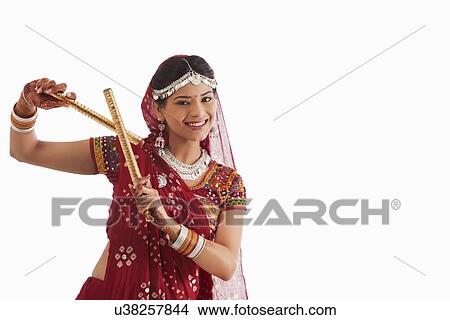 Female dandiya dancer dancing with sticks View Large Photo Image Picture - Female dandiya dancer dancing with sticks . Fotosearch