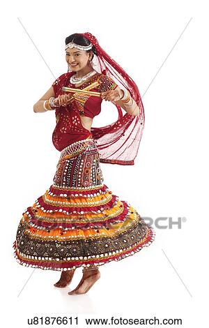 Female dandiya dancer dancing with sticks View Large Photo Image Stock Image - Female dandiya dancer dancing with sticks . Fotosearch