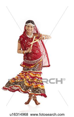 Female dandiya dancer dancing with sticks View Large Photo Image Stock Photo - Female dandiya dancer dancing with sticks . Fotosearch