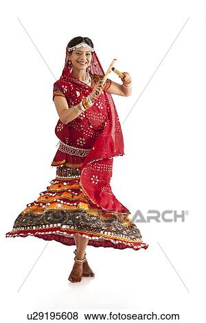 Stock Photo - Female dandiya dancer dancing with sticks . Fotosearch