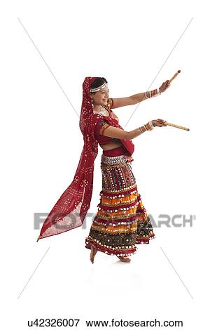 Stock Photo - Female dandiya dancer dancing with sticks . Fotosearch