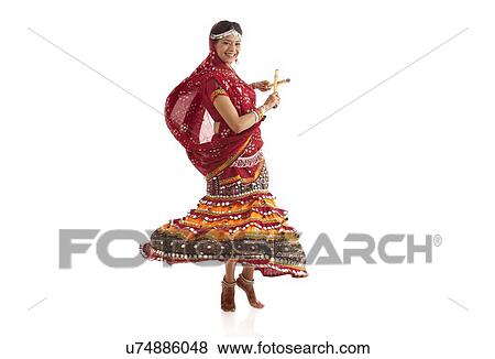 Female dandiya dancer dancing with sticks View Large Photo Image Stock Photo - Female dandiya dancer dancing with sticks . Fotosearch