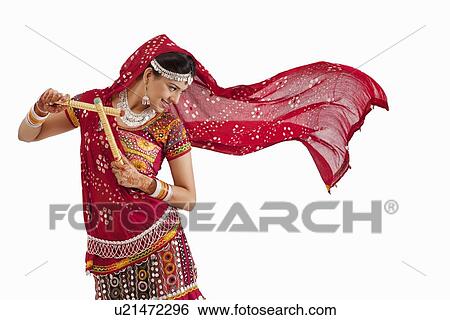 Female dandiya dancer dancing with sticks View Large Photo Image Stock Photograph - Female dandiya dancer dancing with sticks . Fotosearch