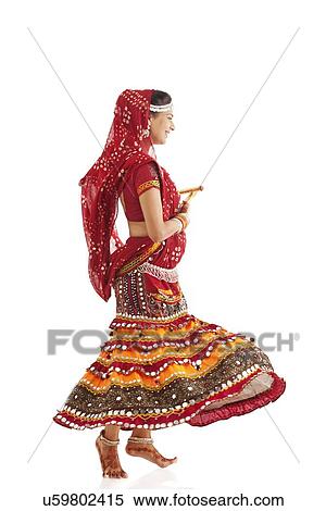 Female dandiya dancer dancing with sticks View Large Photo Image Stock Photography - Female dandiya dancer dancing with sticks . Fotosearch
