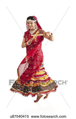 Female dandiya dancer dancing with sticks View Large Photo Image Stock Photography - Female dandiya dancer dancing with sticks . Fotosearch